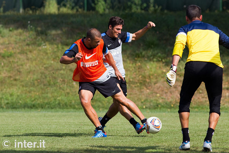 APPIANO GENTILE - Zanetti and Samuel cross legs as they tangle for the ball